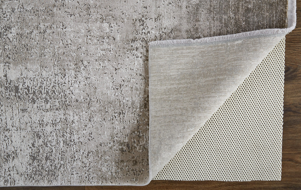 3' X 5' Taupe Ivory And Gold Abstract Power Loom Distressed Area Rug With Fringe