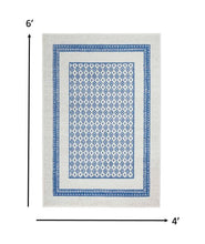 4’ X 6’ Ivory And Blue Geometric Area Rug