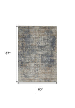 5' X 7' Blue And Beige Abstract Power Loom Distressed Non Skid Area Rug