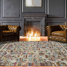 5' X 8' Ivory Blue Pink Gold And Green Geometric Hand Woven Area Rug With Fringe