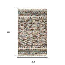 5' X 8' Ivory Blue Pink Gold And Green Geometric Hand Woven Area Rug With Fringe