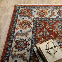 5' X 8' Red Blue Ivory Gold And Navy Oriental Power Loom Stain Resistant Area Rug With Fringe