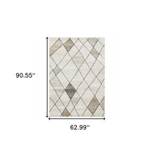 5' X 8' Beige Grey Tan And Brown Geometric Power Loom Stain Resistant Area Rug