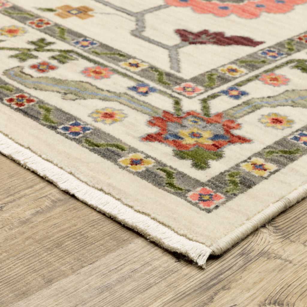 5' X 8' Ivory Green Blues Pink Yellow Rust Brown Tan And Grey Oriental Power Loom Stain Resistant Area Rug With Fringe