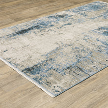 8' X 11' Blue Grey Ivory Light Blue And Dark Blue Abstract Power Loom Stain Resistant Area Rug With Fringe
