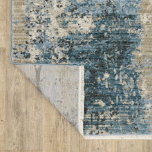 8' X 11' Blue Grey Ivory Light Blue And Dark Blue Abstract Power Loom Stain Resistant Area Rug With Fringe