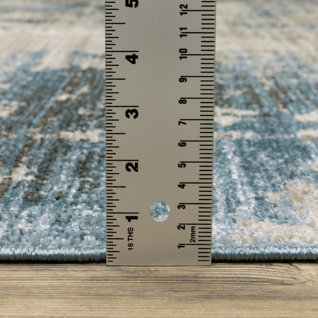 8' X 11' Blue Grey Ivory Light Blue And Dark Blue Abstract Power Loom Stain Resistant Area Rug With Fringe