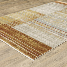 6' X 9' Rust Gold Blue Grey Ivory And Tan Geometric Power Loom Stain Resistant Area Rug With Fringe