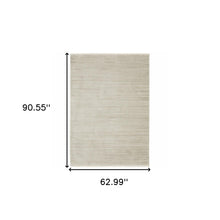 5' X 8' Ivory Beige Taupe And Tan Geometric Power Loom Stain Resistant Area Rug With Fringe