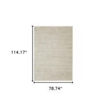 6' X 9' Ivory Beige Taupe And Tan Geometric Power Loom Stain Resistant Area Rug With Fringe