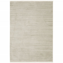 6' X 9' Ivory Beige Taupe And Tan Geometric Power Loom Stain Resistant Area Rug With Fringe