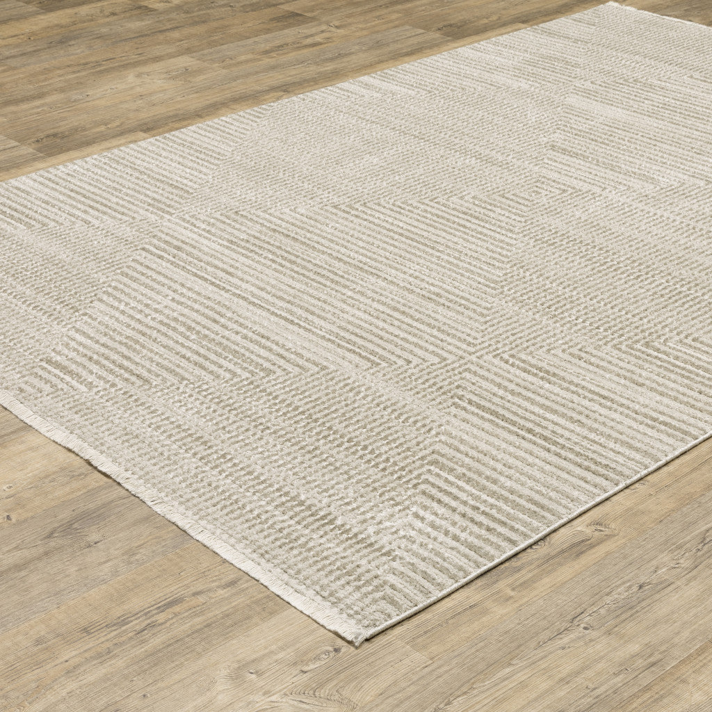 8' X 11' Ivory Beige Taupe And Tan Geometric Power Loom Stain Resistant Area Rug With Fringe
