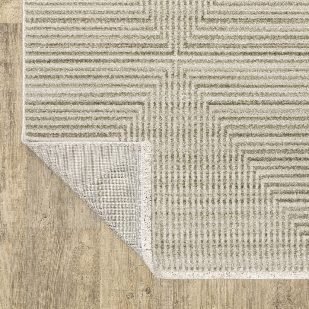 8' X 11' Ivory Beige Taupe And Tan Geometric Power Loom Stain Resistant Area Rug With Fringe