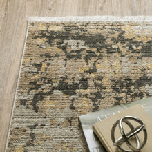 6' X 9' Grey Gold Black Charcoal And Beige Abstract Power Loom Stain Resistant Area Rug With Fringe
