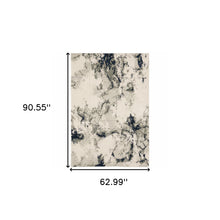 5' X 7' Grey Black And Ivory Abstract Power Loom Stain Resistant Area Rug