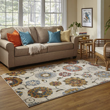 5' X 8' Ivory Blue Gold Green Orange Rust And Teal Floral Power Loom Stain Resistant Area Rug