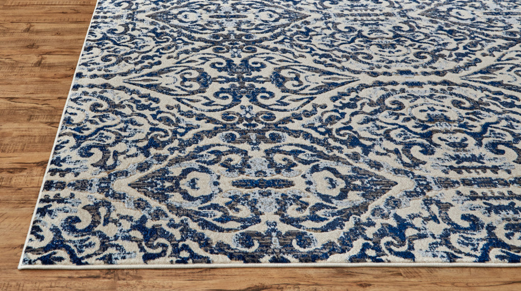 Blue Ivory And Black Floral Distressed Stain Resistant Area Rug - 2' X 4'