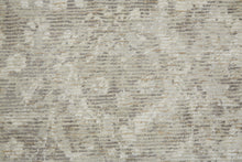 5' X 8' Ivory And Tan Abstract Hand Woven Area Rug