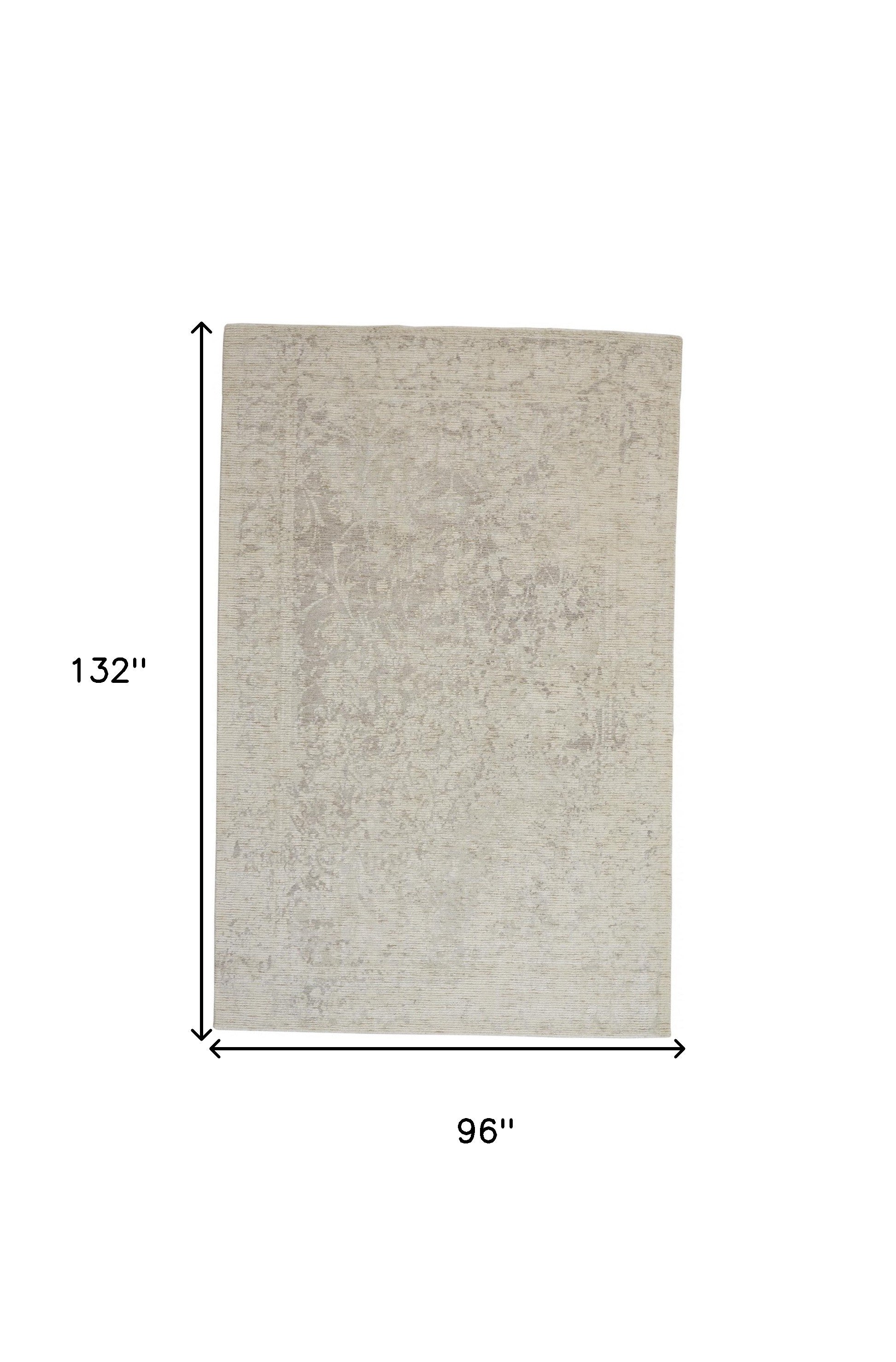 5' X 8' Ivory And Tan Abstract Hand Woven Area Rug