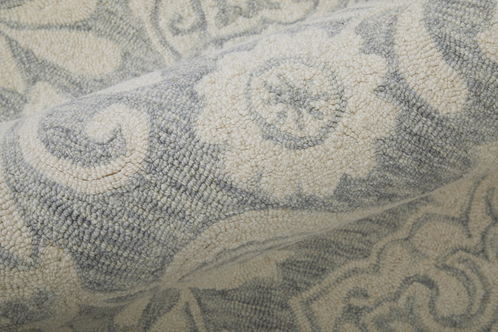 Blue And Ivory Wool Paisley Tufted Handmade Stain Resistant Area Rug - 5' x 8'