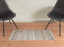 5' X 8' Tan Gray And Ivory Geometric Hand Woven Stain Resistant Area Rug With Fringe