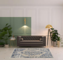 4' X 6' Ivory And Blue Floral Power Loom Distressed Area Rug