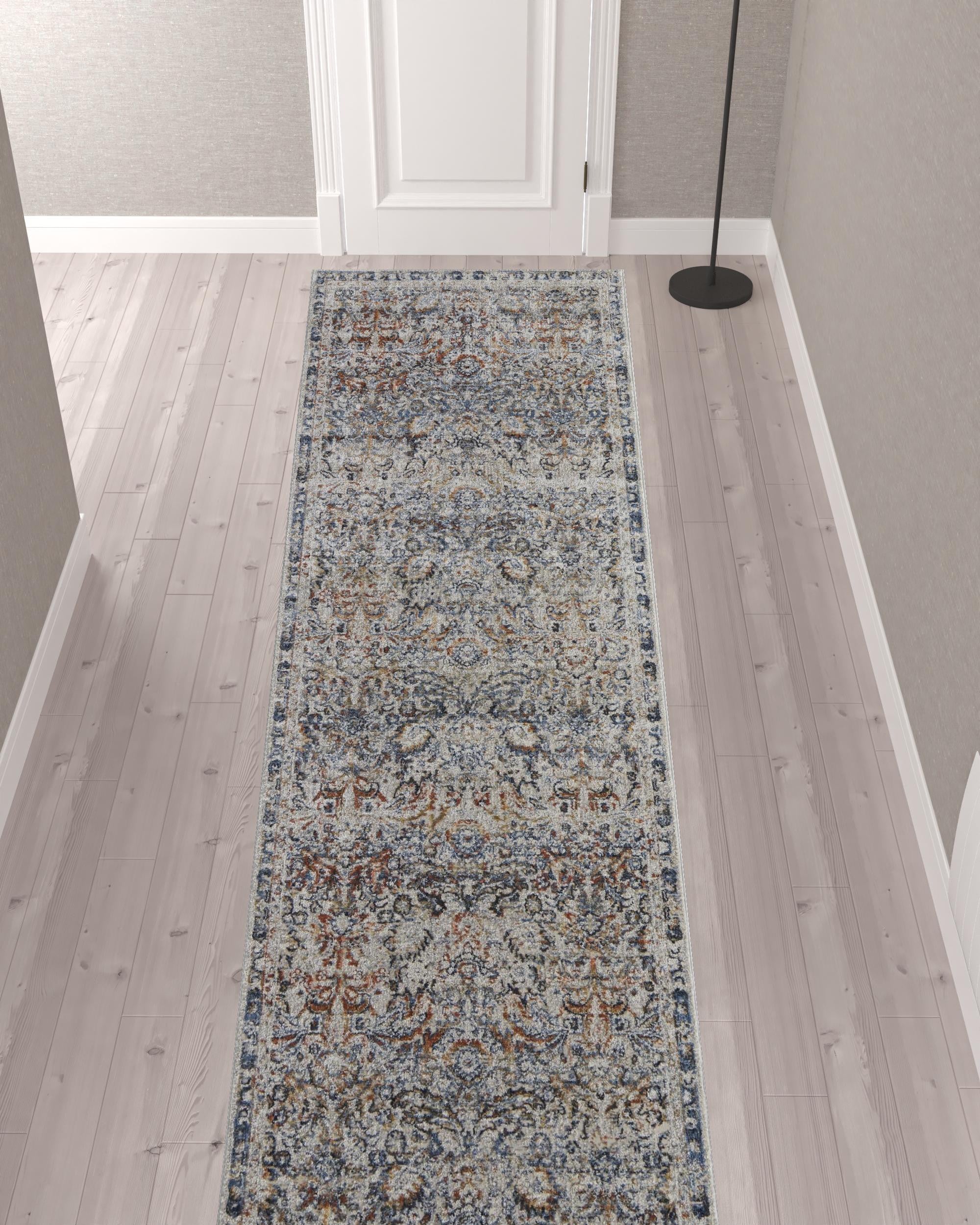 5' X 8' Tan Blue And Orange Floral Power Loom Distressed Area Rug With Fringe