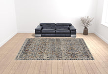 5' X 8' Tan Blue And Orange Floral Power Loom Distressed Area Rug With Fringe
