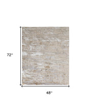 Tan Orange And Ivory Abstract Power Loom Distressed Area Rug - 4' x 6'